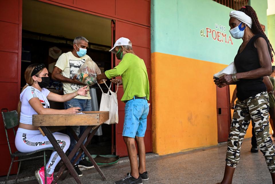 Cubans buy a donation food module at a supermarket in Arroyo Naranjo municipality in Havana, on August 11, 2021. - Cubans receive a free food module with products donated by several countries in an attempt to to alleviate the shortage of food and medicines following the difficult situation caused by Covid-19 in the country. (Photo by YAMIL LAGE / AFP) (Photo by YAMIL LAGE/AFP via Getty Images)