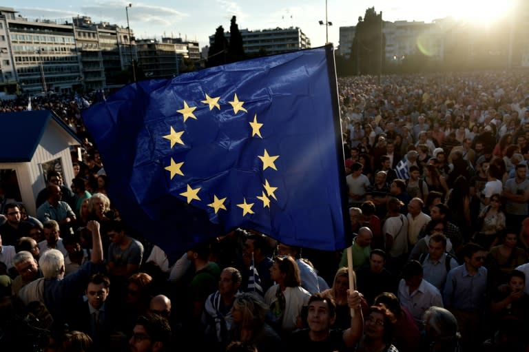 Protesters hold a European Union flag as they demonstrate during a pro-European demonstration in front of the Greek parliament in Athens on June 22, 2015