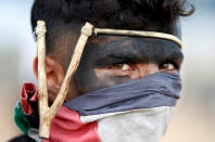 <p>A Palestinian demonstrator with a slingshot takes part in a protest against the U.S. Embassy’s move to Jerusalem, at the Israel-Gaza border east of Gaza City, May 14, 2018. (Photo: Mohammed Salem/Reuters) </p>