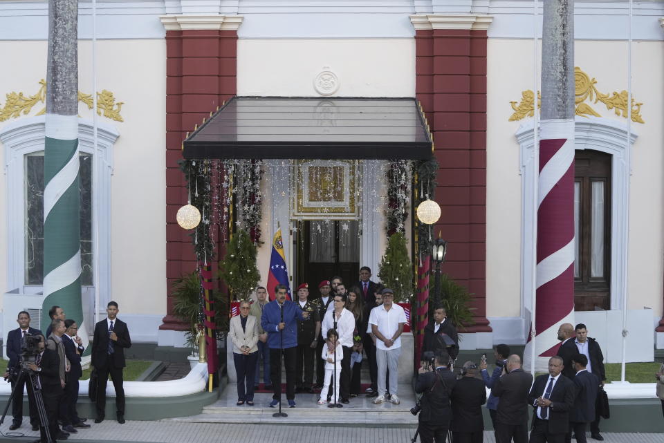 Venezuelan President Maduro speaks, left, as he stands with Alex Saab, behind second microphone, at Miraflores presidential palace in Caracas, Venezuela, Wednesday, Dec. 20, 2023. The United States freed Saab, who was arrested on a U.S. warrant for money laundering in 2020, in exchange for the release of 10 Americans imprisoned in Venezuela, U.S. officials said Wednesday. (AP Photo/Matias Delacroix)