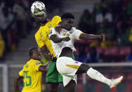 Cameroon's Michael Ngadeu-Ngadjui, top left, and Cape Verde's Joao Paulo Fernandes, jump for the ball during the African Cup of Nations 2022 group A soccer match between Cape Verde and Cameron at the Olembe stadium in Yaounde, Cameroon, Monday, Jan. 17, 2022. (AP Photo/Themba Hadebe)