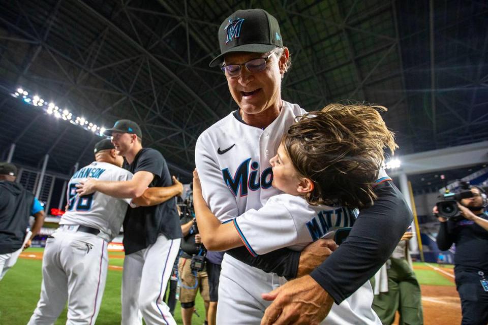 Miami Marlins manager Don Mattingly embraces his son Louis Riley Mattingly after the Marlins defeated the Braves 12-9 during his final MLB game at loanDepot park in the Little Havana neighborhood of Miami, Florida, on Wednesday, October 5, 2022.