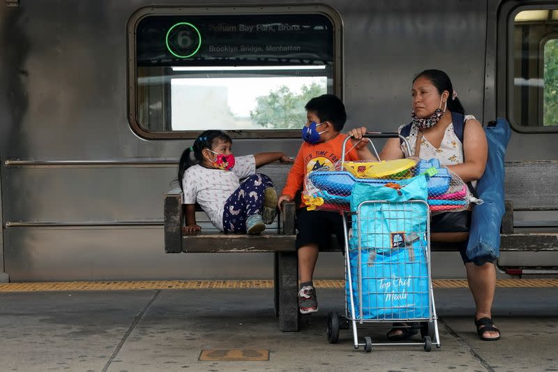 FILE PHOTO: People wait for the subway in New York City