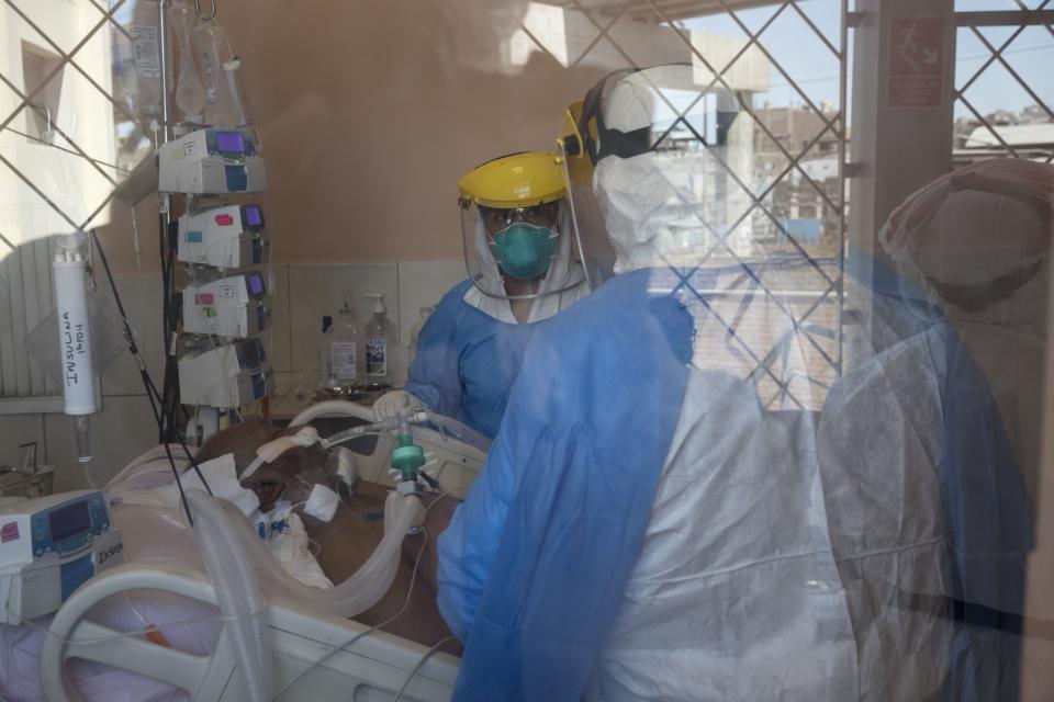 Doctors tend to a patient inside the intensive care unit for people infected with the new coronavirus, at the 2 de Mayo Hospital, in Lima, Peru, Friday, April 17, 2020. (AP Photo/Rodrigo Abd)
