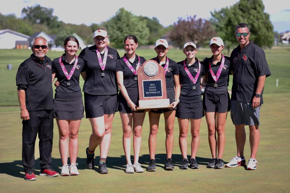 Coaches and members of the Roland-Story girls golf team pose with their 2024 Class 2A state runner-up trophy after taking second at the 2A girls state golf tournament held Thursday and Friday at the Cedar Pointe Golf Course in Boone, Iowa.