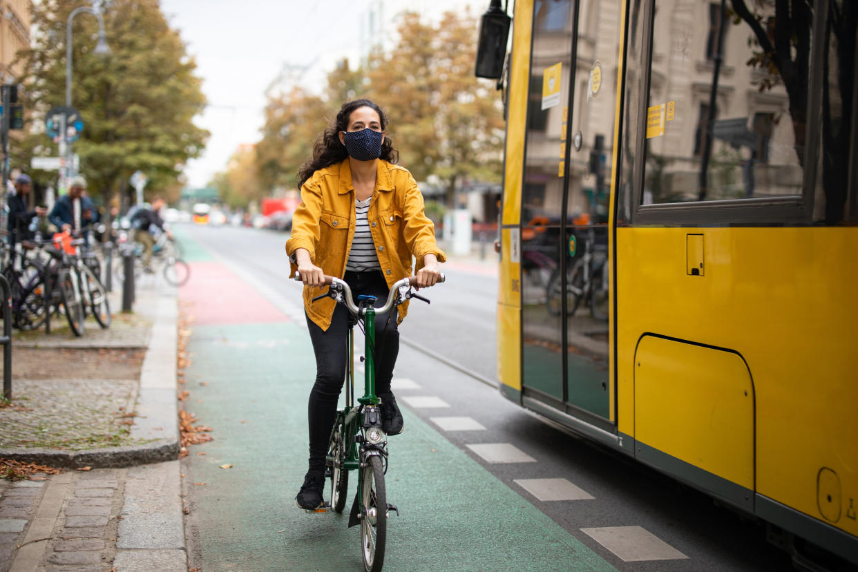 Woman riding a bicycle with a mask on