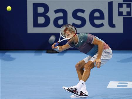 Grigor Dimitrov of Bulgaria returns the ball during his quarter final match against Switzerland's Roger Federer at the Swiss Indoors ATP tennis tournament in Basel October 25, 2013. REUTERS/Arnd Wiegmann