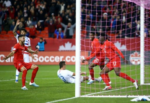 Alphonso Davies (12) celebrates firing Canada into the lead in their upset victory over the United States