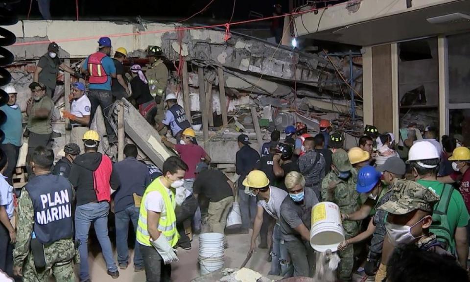 Rescue teams look for people trapped in the rubble at the Enrique Rebsamen elementary school in Mexico City, in this still taken from Mexican TV.