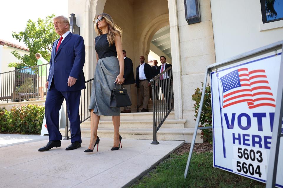 Former U.S. President Donald Trump and former first lady Melania Trump walk together after voting at a polling station setup in the Morton and Barbara Mandel Recreation Center on November 08, 2022 in Palm Beach, Florida.