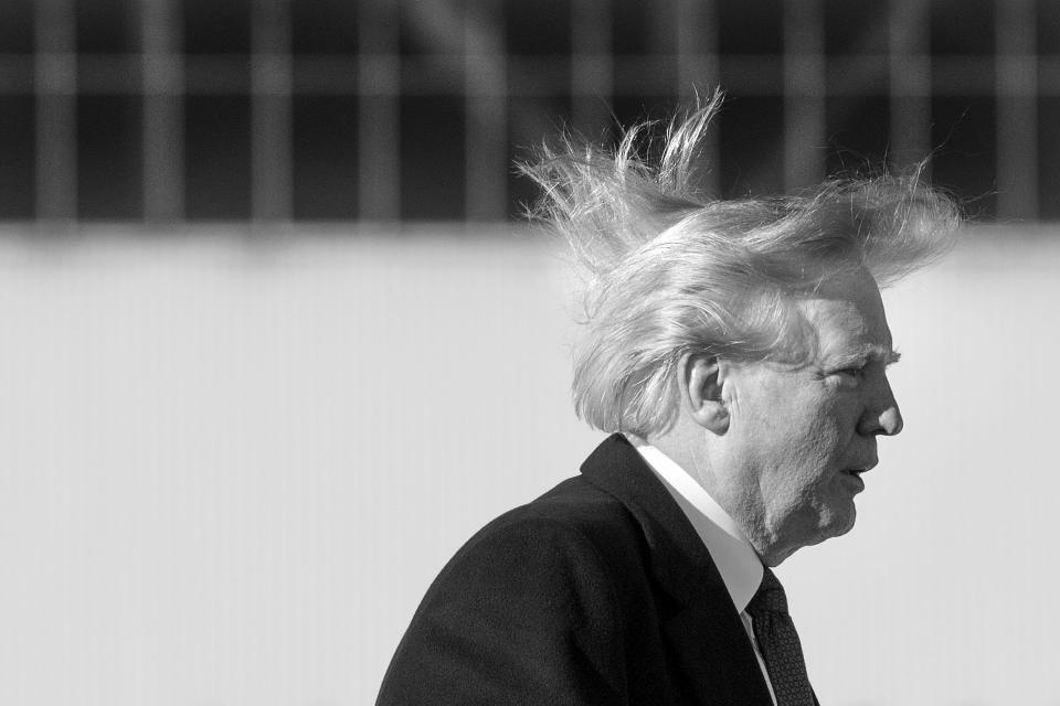 Donald Trump's hair blows in the wind as he boards Air Force One in 2017. (Photo: JIM WATSON/AFP via Getty Images)