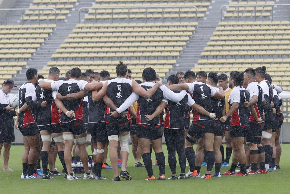 Japan team's players gather in circle during a training session, ahead of their Rugby World Cup Pool A match against Scotland as Typhoon Hagibis approaches Saturday, Oct. 12, 2019 in Tokyo. (Yuki Sato/Kyodo News via AP)