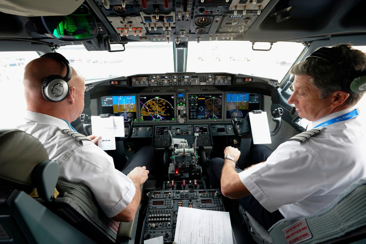 American Airlines pilot captain Pete Gamble, left, and first officer John Konstanzer conduct a pre-flight check in the cockpit of a Boeing 737 Max jet before taking off from Dallas Fort Worth airport on Dec. 2, 2020, in Grapevine, Texas. (AP Photo/LM Otero, File)