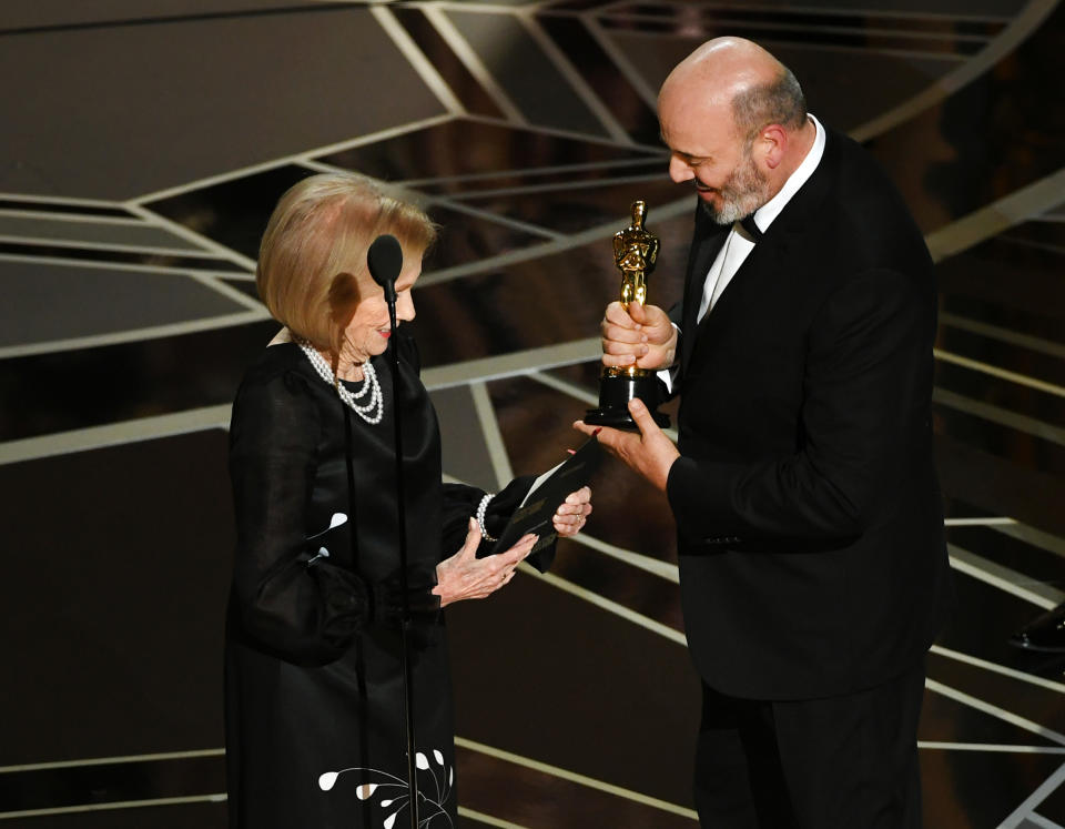 Costume designer Mark Bridges accepts Best Costume Design for 'Phantom Thread' from actor Eva Marie Saint onstage during the 90th Annual Academy Awards at the Dolby Theatre at Hollywood & Highland Center on March 4, 2018 in Hollywood.