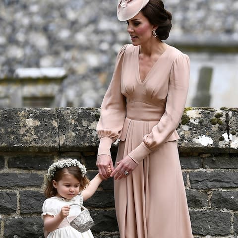 The Duchess of Cambridge holds Princess Charlotte's hand at the wedding of her sister Pippa Middleton - Credit: Justin Tallis/AFP