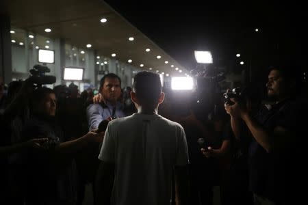 Arnovis Guido talks to the media after being reunited with his daughter Maybelline Guido at the Mons. Oscar Arnulfo Romero International Airport in San Luis Talpa, El Salvador, June 28, 2018. REUTERS/Jose Cabezas