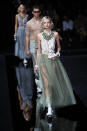 Models wear creations as part of the Emporio Armani Spring-Summer 2020 collection, unveiled during the fashion week, in Milan, Italy, Thursday, Sept. 19, 2019. (AP Photo/Antonio Calanni)