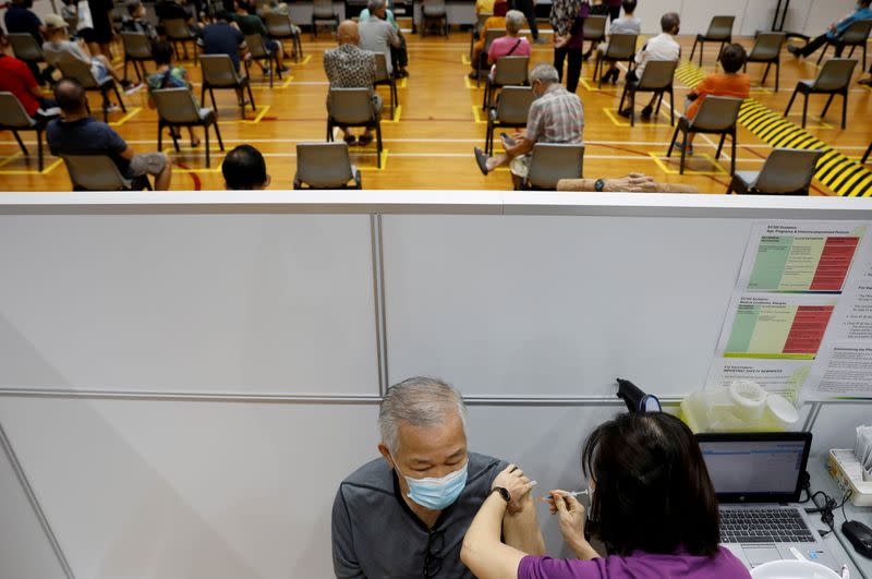FILE PHOTO: A man receives his vaccination at a coronavirus disease (COVID-19) vaccination center in Singapore