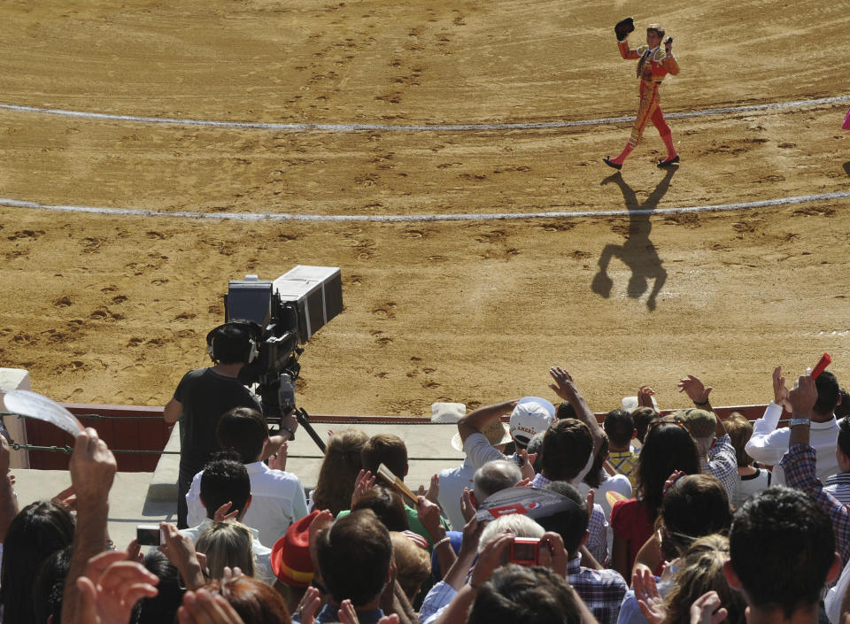 A TV camera films as Spanish bullfighter Julian Lopez 'El Juli' waves during a bullfight in Valladolid, Spain Wednesday Sept. 5, 2012. Bullfights returned live to Spanish state TV Wednesday evening, six years after the fights were banned from the widely watched public channel with the broadcast featuring one of Spain’s most storied bullfighters and giving a boost to a tradition hit hard by declining popularity and a dire economic crisis. The RTVE broadcast from the northern city of Valladolid is a big victory for pro-bullfighting forces that saw bullfighting banned altogether this year in the northeastern region of Catalonia; it’s a defeat for animal rights activists who denounce bullfighting as barbaric. The transmissions were halted in 2006 by Spain’s previous Socialist administration, which said they were costly and coincided with key TV viewing hours for young children. (AP Photo / Israel L. Murillo)