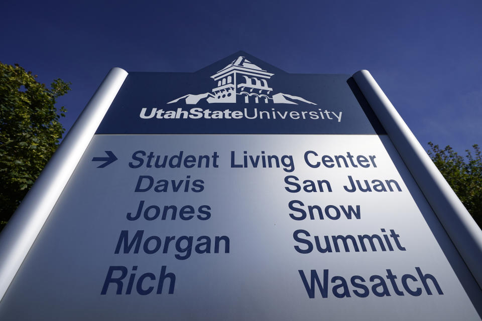 A sign shows the dormitory's at Utah State University Wednesday, Sept. 2, 2020, in Logan, Utah. About 300 students are quarantined to their rooms this week, but not because anyone got sick or tested positive. Instead, the warning bells came from the sewage. Colleges around the country are monitoring wastewater in hopes of stopping coronavirus outbreaks before they get out of hand. Utah State became at least the second school to quarantine hundreds of students after sewage tests detected the virus. (AP Photo/Rick Bowmer)