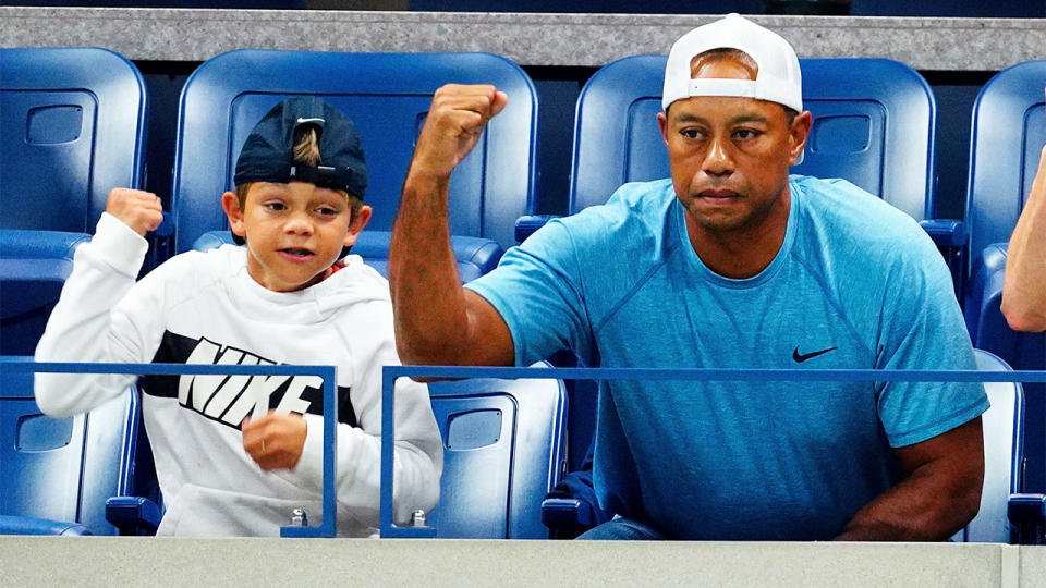 Tiger Woods and his son Charlie (pictured) cheer on.