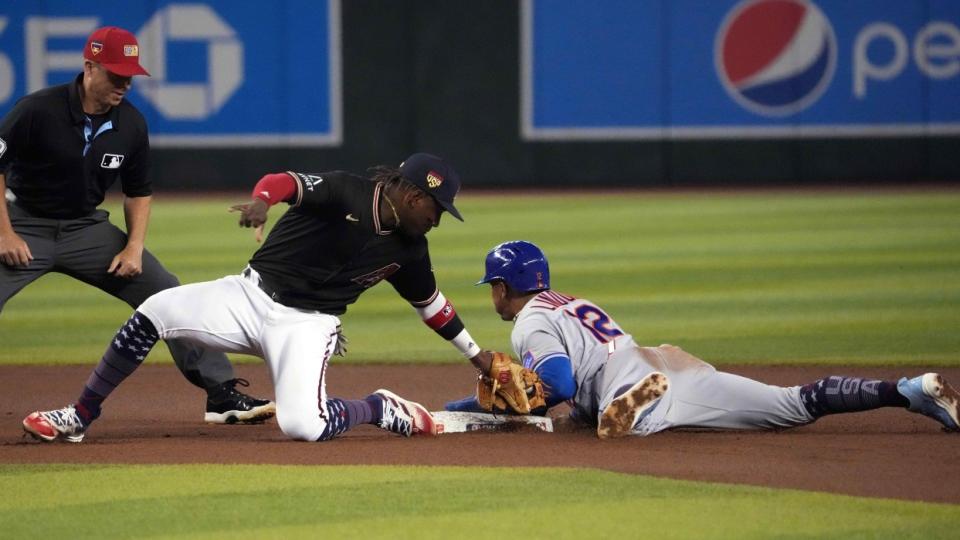 New York Mets shortstop Francisco Lindor (12) beats the tag of Arizona Diamondbacks second baseman Geraldo Perdomo (2) to steal second base during the fourth inning at Chase Field