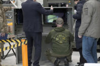 Ukrainian Minister of Defense Oleksii Reznikov, center, looks at the screen control of a Ground Master 200 (GM200) radar during a visit at Thales radar factory in Limours, south west of Paris, France, Wednesday, Feb. 1, 2023. France has guaranteed Kyiv the delivery of a Ground Master 200 (GM200) radar, produced by the French manufacturer Thales. This medium-range radar is capable of spotting enemy aircraft at 250 km and engaging them at 100 km, whether they are flying at low speed and low altitude like drones or at high altitude like fighter planes. (AP Photo/Christophe Ena)