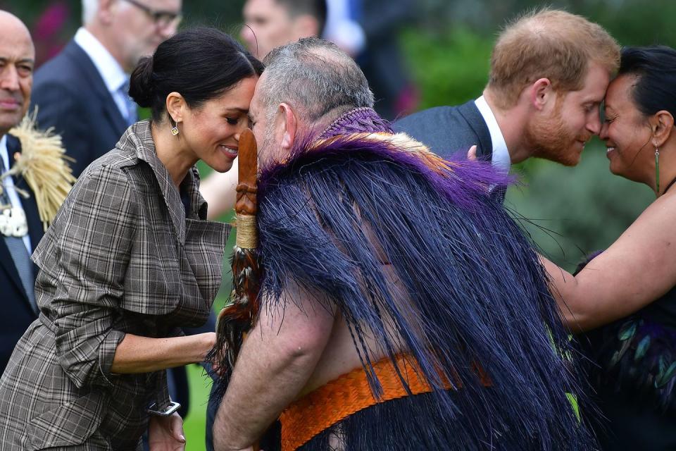 Prince Harry and Meghan Markle both receive hongi at a welcoming ceremony in Wellington.