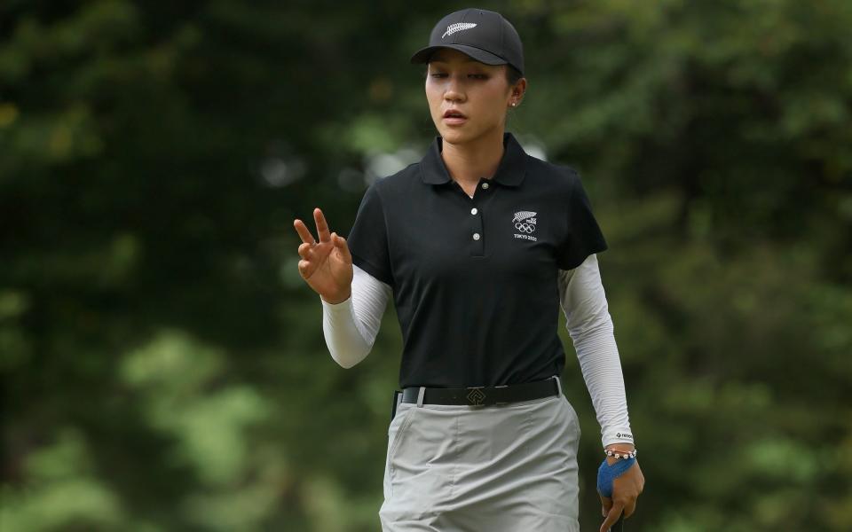 Lydia Ko of Team New Zealand waves after making a birdie on the second hole during the final round. - Mike Ehrmann/Getty Images