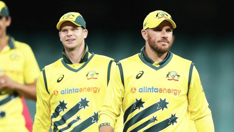 Steve Smith (pictured left) and Aaron Finch (pictured right) walk off the field.