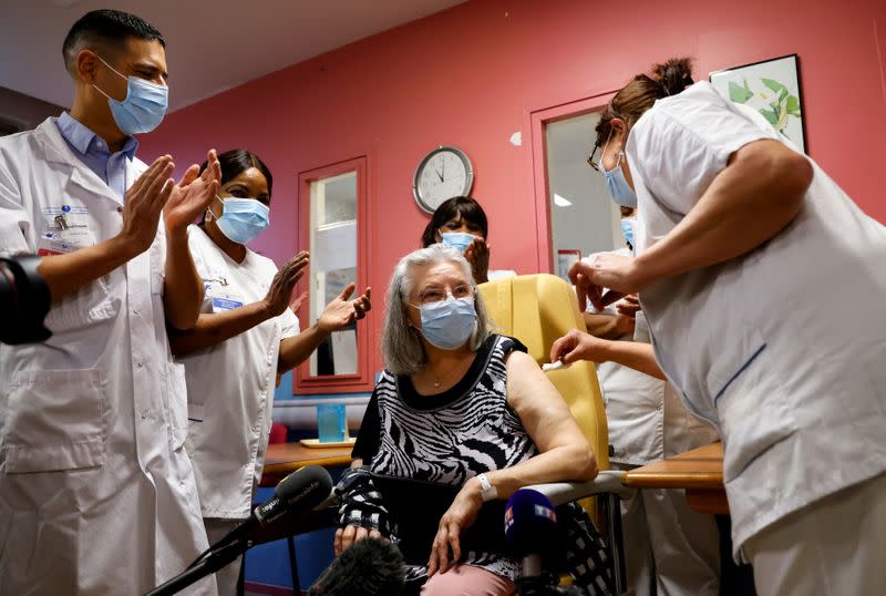 Mauricette, a 78-year-old French woman, receives the first dose of the Pfizer-BioNTech COVID-19 vaccine in the country, in Sevran