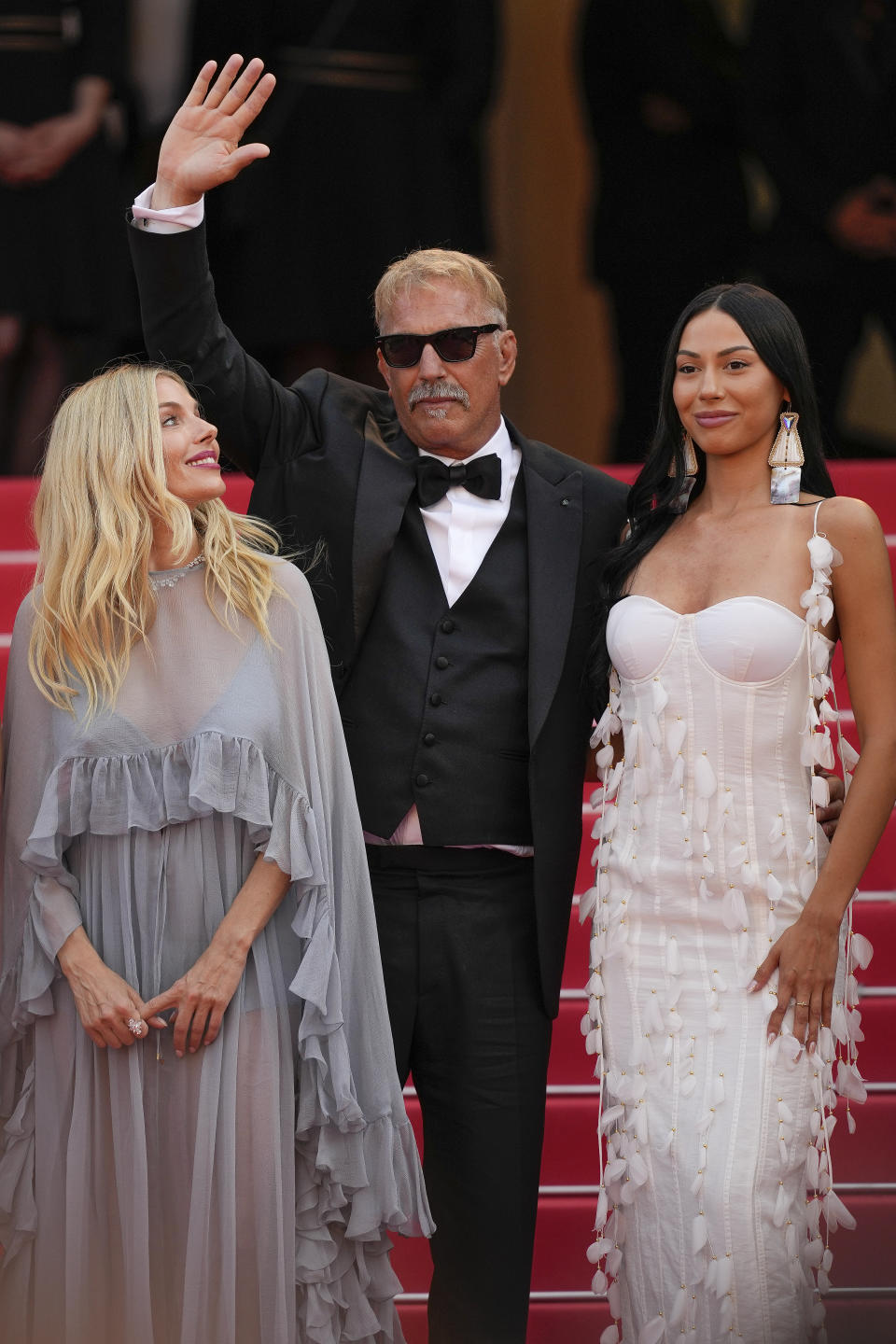 Sienna Miller, from left, Kevin Costner and Wase Chief pose for photographers upon arrival at the premiere of the film 'Horizon: An American Saga' at the 77th international film festival, Cannes, southern France, Sunday, May 19, 2024. (Photo by Andreea Alexandru/Invision/AP)