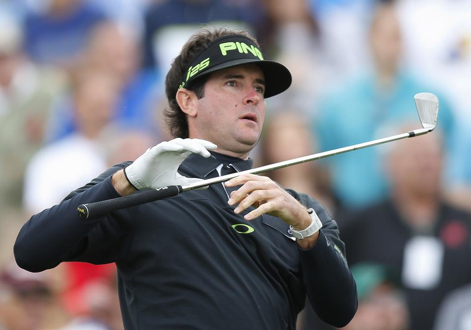 Bubba Watson lets go of his iron as he watches his tee shot on the seventh hole during the second round of the Phoenix Open golf tournament on Friday, Jan. 31, 2014, in Scottsdale, Ariz. (AP Photo/Ross D. Franklin)