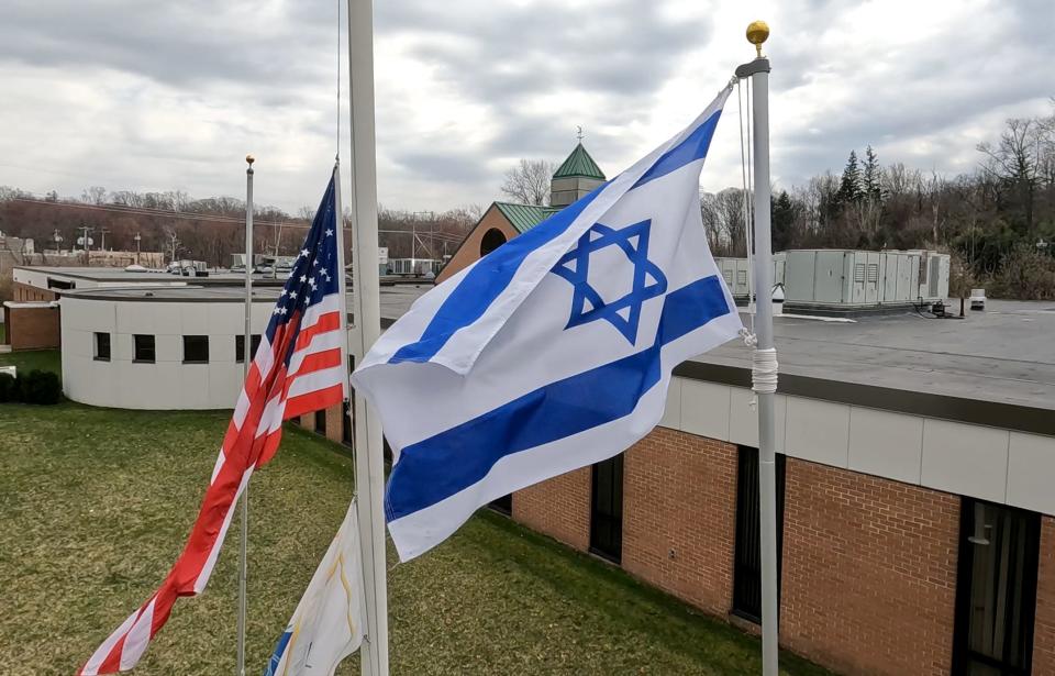 The Israeli flag flies at Ramapo Town Hall in Airmont March 20, 2024. The American flag next to it was at half-mast.