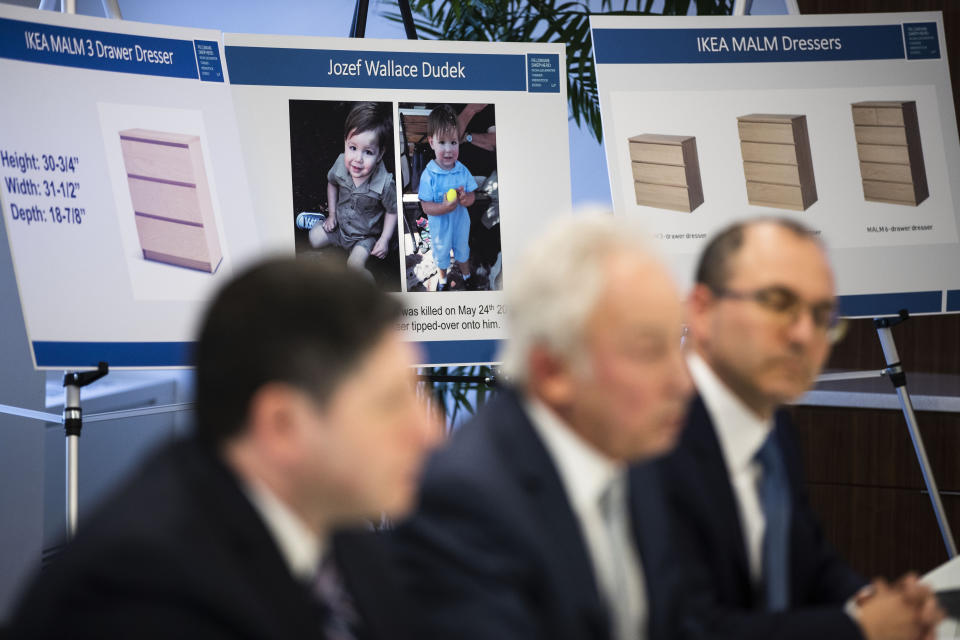 Placards showing images of Jozef Dudek and IKEA's Malm dressers are displayed during a news conference in Philadelphia, Monday, Jan. 6, 2020. IKEA has agreed to pay $46 million to the parents of a 2-year-old boy who died of injuries suffered when a 70-pound recalled dresser tipped over onto him, the family’s lawyers said Monday. (AP Photo/Matt Rourke)