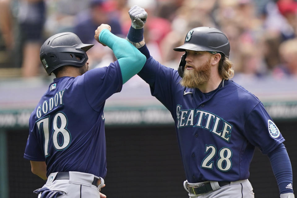 Seattle Mariners' Jake Fraley, right, and Jose Godoy celebrate after Fraley hit a two-run home run in the fourth inning of a baseball game against the Cleveland Indians, Sunday, June 13, 2021, in Cleveland. (AP Photo/Tony Dejak)