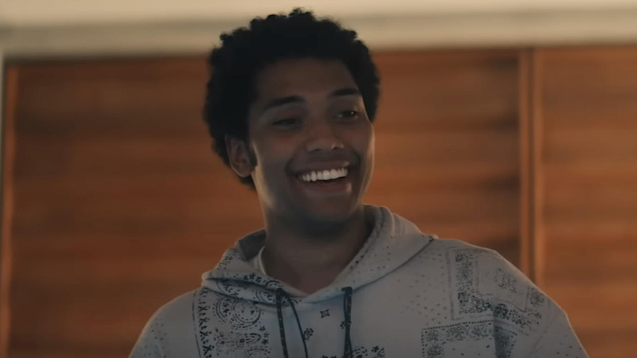  Chance Perdomo's Andre wearing a hoodie and smiling in Gen V. 