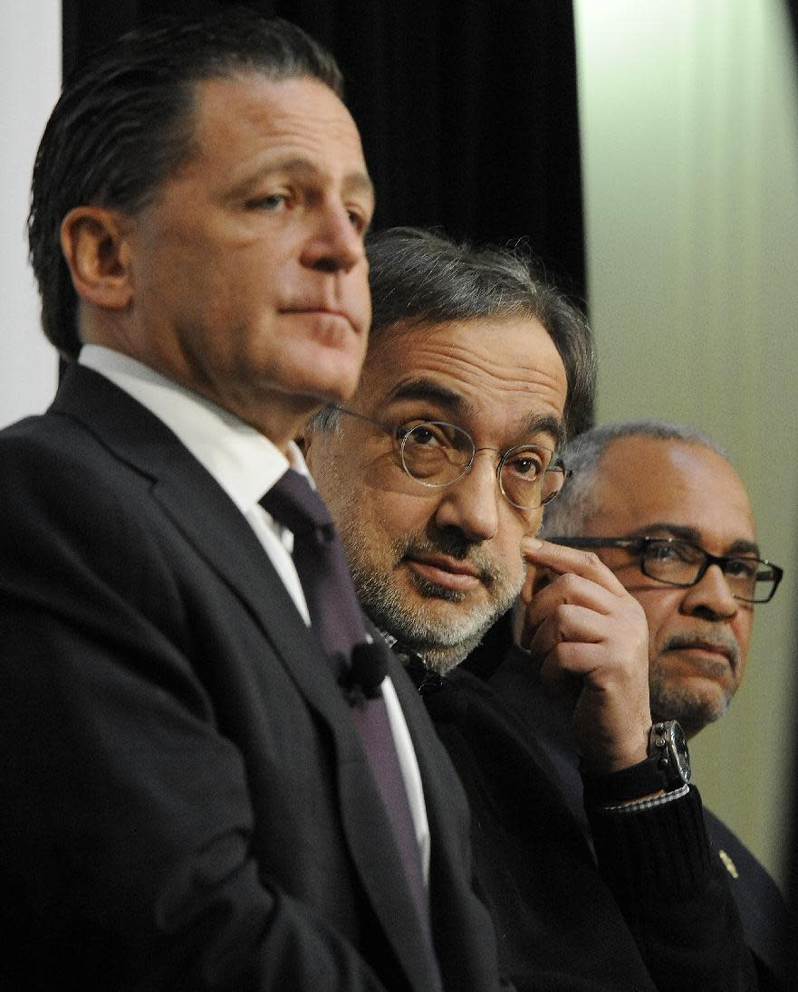 From left, Chairman of Rock Ventures and Quicken Loans Dan Gilbert, Fiat-Chrysler CEO Sergio Marchionne and Detroit Deputy Mayor Kirk Lewis hold a news conference to announce that Chrysler is setting up a downtown office for Marchionne and up to 70 staffers at the Dime Building in Detroit, on Monday, April 30, 2012. (AP Photo/The Detroit News, Daniel Mears)