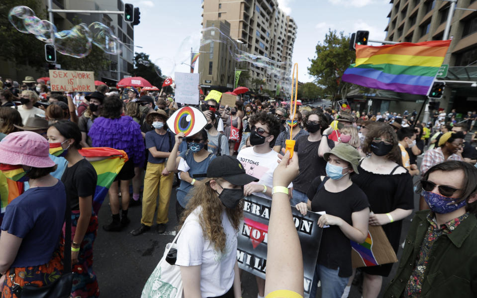 Hundreds of protesters march in Sydney, Saturday, March 6, 2021, ahead of the annual Gay and Lesbian Mardi Gras. The protesters say they want to restore the protest roots of Mardi Gras and challenge systems of injustice. (AP Photo/Rick Rycroft)