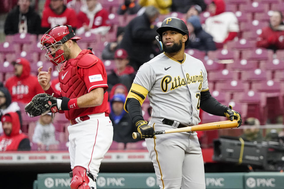 Pittsburgh Pirates' Canaan Smith-Njigba, right, reacts after striking out during the ninth inning of a baseball game against the Cincinnati Reds, Saturday, April 1, 2023, in Cincinnati. (AP Photo/Joshua A. Bickel)