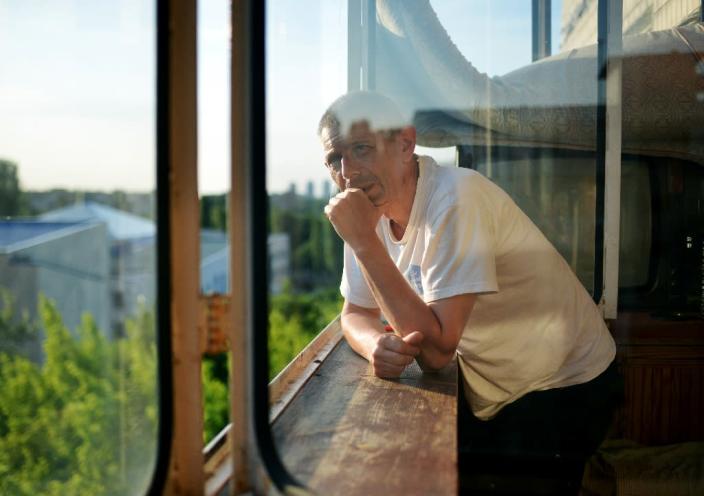 Ukrainian man Andrei, 52, standing on the balcony of a refuge home in Kiev, after he fled the separatist east out of fear for his life for being gay (AFP Photo/Genya Savilov)
