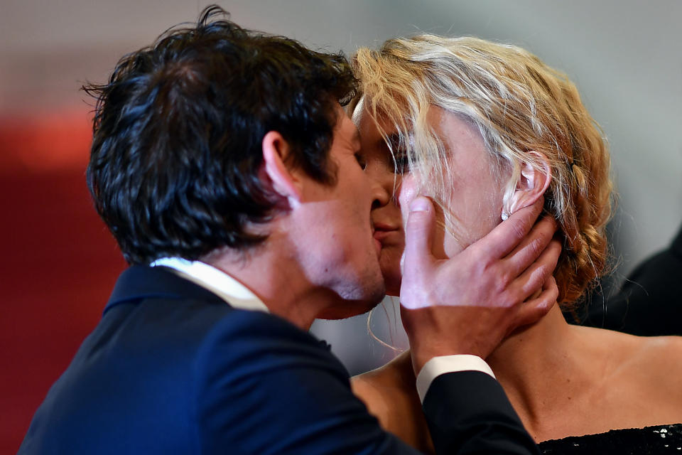 French-Canadian actor Niels Schneider (L) kisses his partner Belgian actress Virginie Efira as they leave the Festival Palace after the screening of the film 