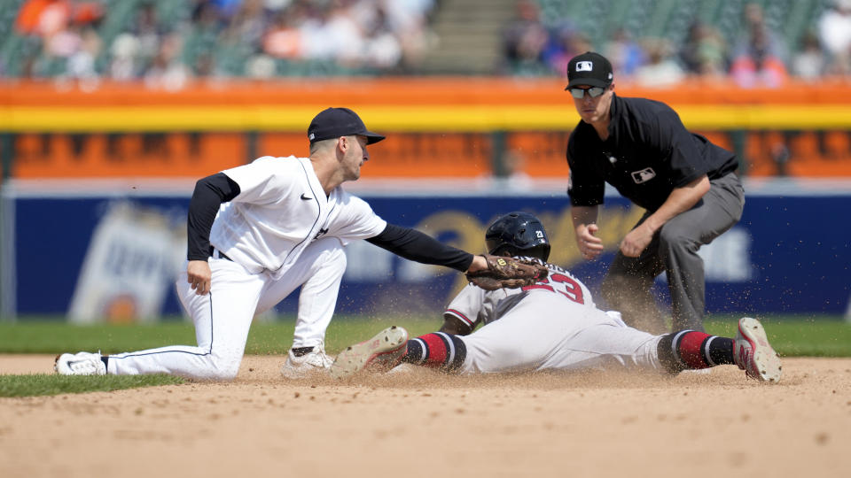Atlanta Braves center fielder Michael Harris II (23) steals second base under the tag of Detroit Tigers' Zack Short in the eighth inning during the first baseball game of a doubleheader, Wednesday, June 14, 2023, in Detroit. (AP Photo/Paul Sancya)