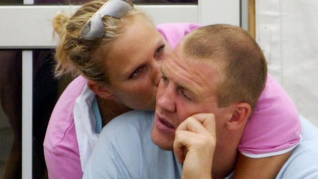 Zara Phillips in a pink top kissing Mike Tindall on the cheek