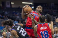 Detroit Pistons center Isaiah Stewart (28) pulls down an offensive rebound between teammate Cory Joseph (18) and Sacramento Kings center Richaun Holmes (22) during the first quarter of an NBA basketball game in Sacramento, Calif., Wednesday, Jan. 19, 2022. (AP Photo/José Luis Villegas)