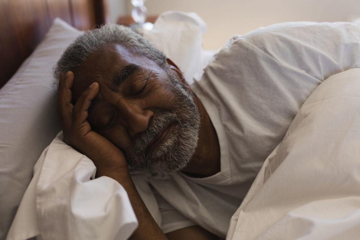 Close-up of senior African American man sleeping in bedroom