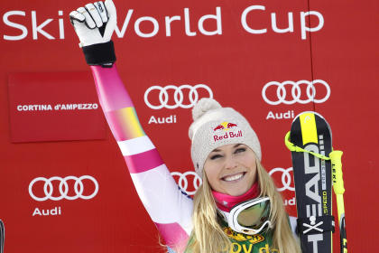 Lindsey Vonn celebrates on the podium after winning an alpine ski, women&#39;s World Cup super-G, in Cortina d&#39;Ampezzo, Italy, Monday, Jan. 19, 2015. Lindsey Vonn won a super-G Monday for her record 63rd World Cup victory and celebrated with an embrace from a surprise visitor, boyfriend Tiger Woods. The American broke Annemarie Moser-Proell&#39;s 35-year-old record of 62 World Cup wins with a flawless run down the Olympia delle Tofane course, finishing 0.85 ahead of Anna Fenninger of Austria. (AP Photo/Andrea Solero, Ansa)