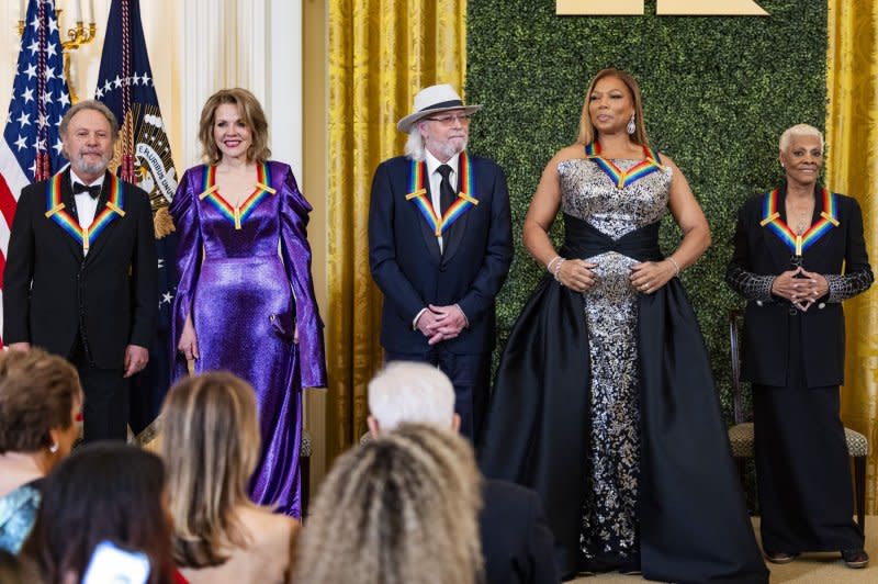 Left to right, Billy Crystal, Renee Fleming, Barry Gibb, Queen Latifah and Dionne Warwick stand in the East Room on Sunday. Photo by Jim Lo Scalzo/UPI