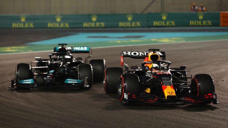 A photo of Max Verstappen passing Lewis Hamilton. 