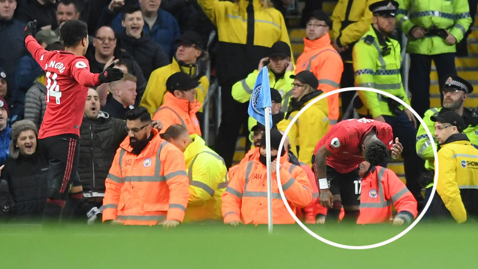 Pictured on the right, United midfielder Fred was struck by a projectile thrown from the crowd.